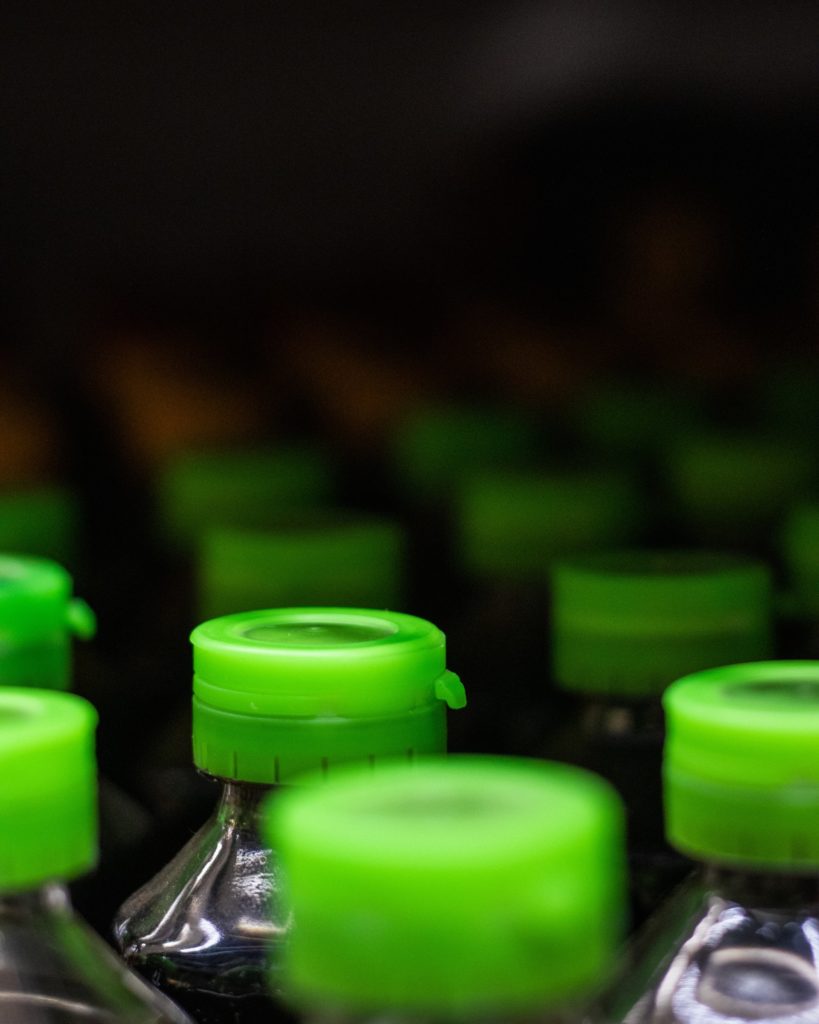 Image of the green caps on top of plastic water bottles.