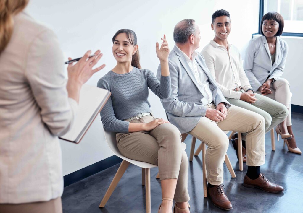 Shot of a group of new employees having a discussion with the recruiter at an office