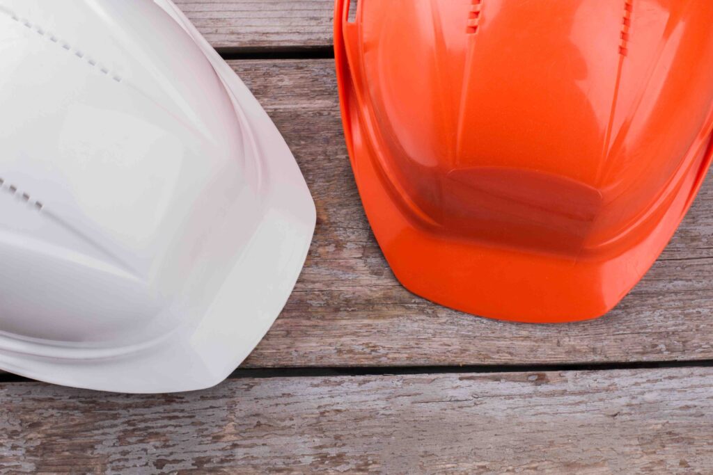 A Picture of Two Plastics Hardhats worn by plastics candidates hired with AJ Augur's Help