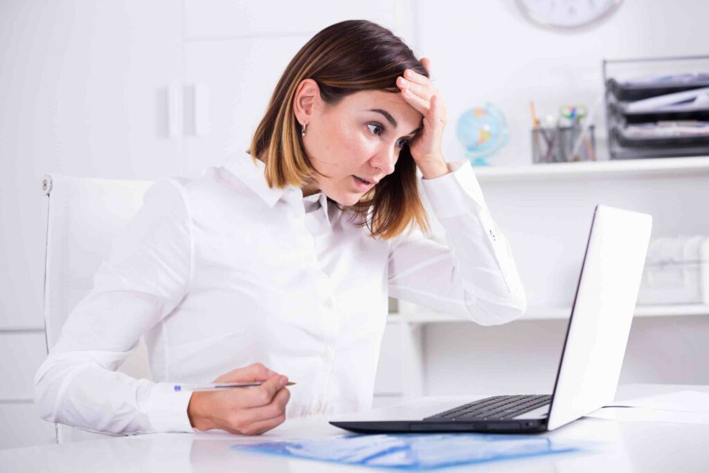 An HR representative working within the plastics industry holding her hand to her forehead indicating stress. She is experiencing one of the common HR challenges in the Plastics Industry.