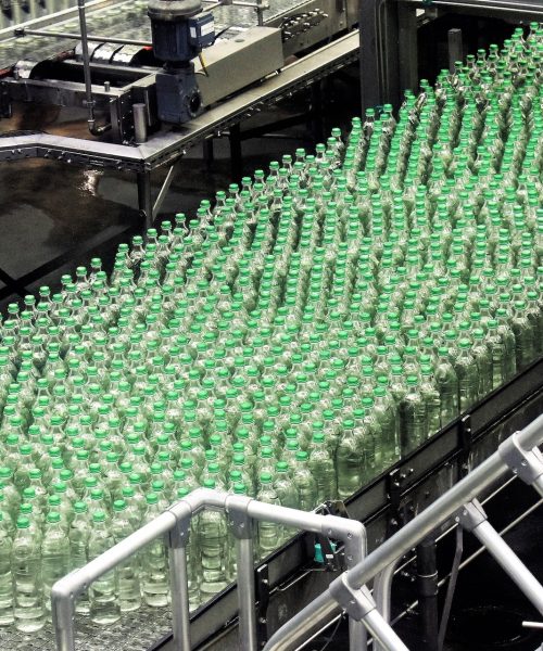 An assembly line of plastic water bottles in a factory.